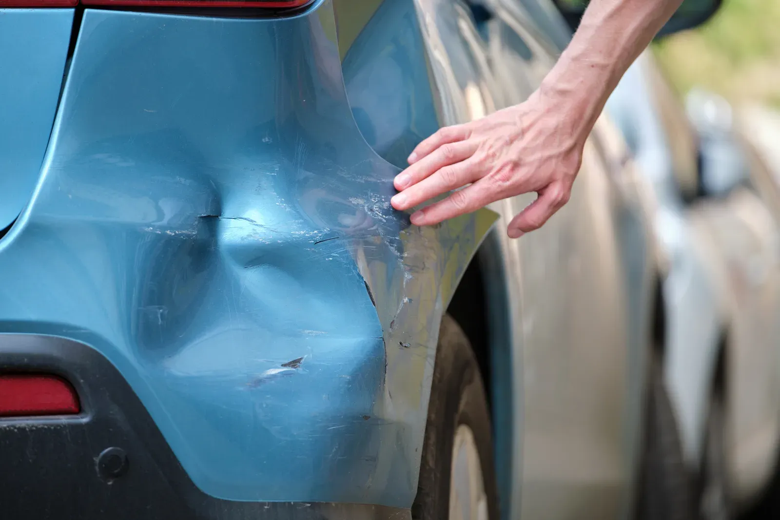 Fender and bumper damage from striking a fixed roadside object