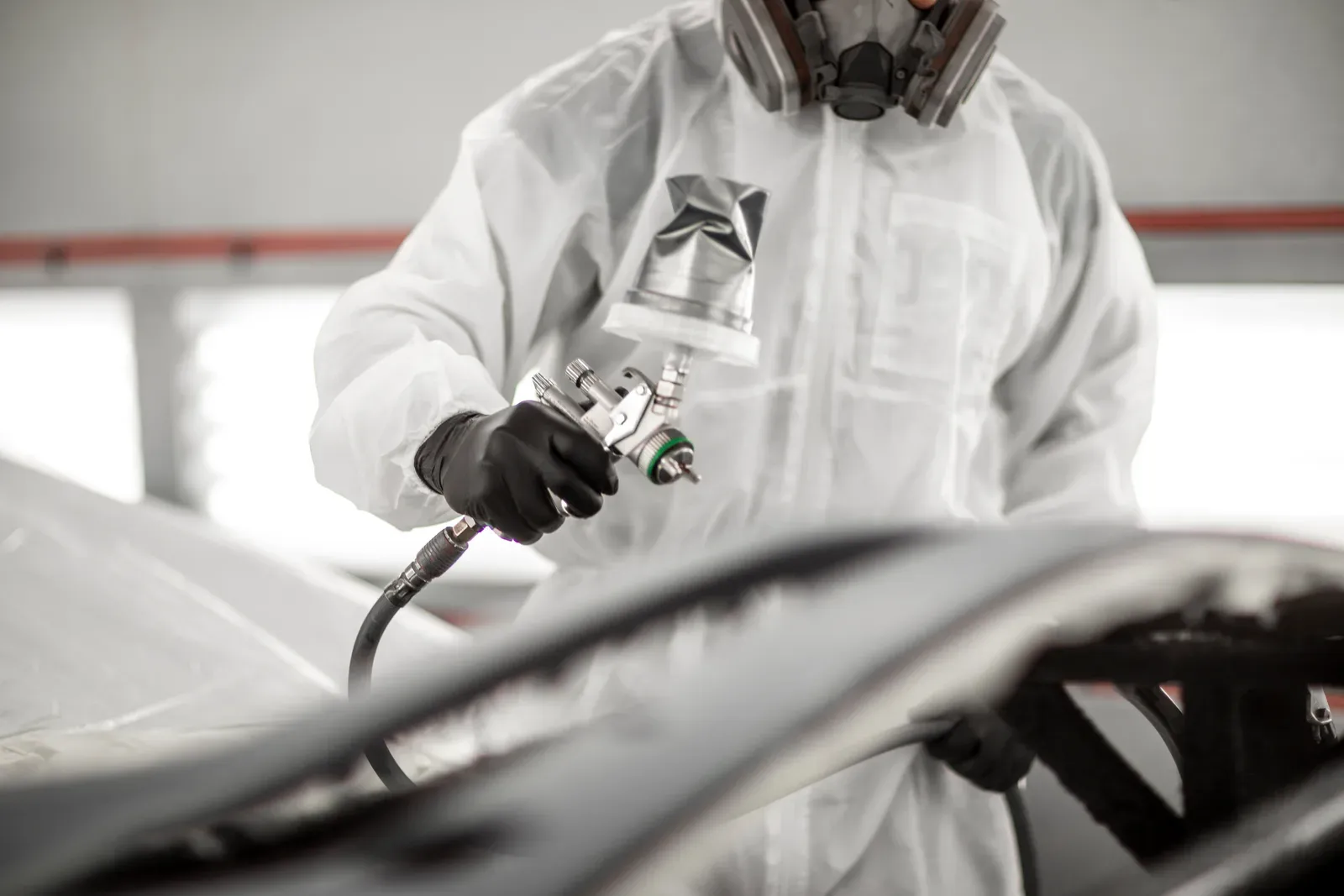 Refinish work in the spray booth at Collision Auto Center for a vehicle from Maple