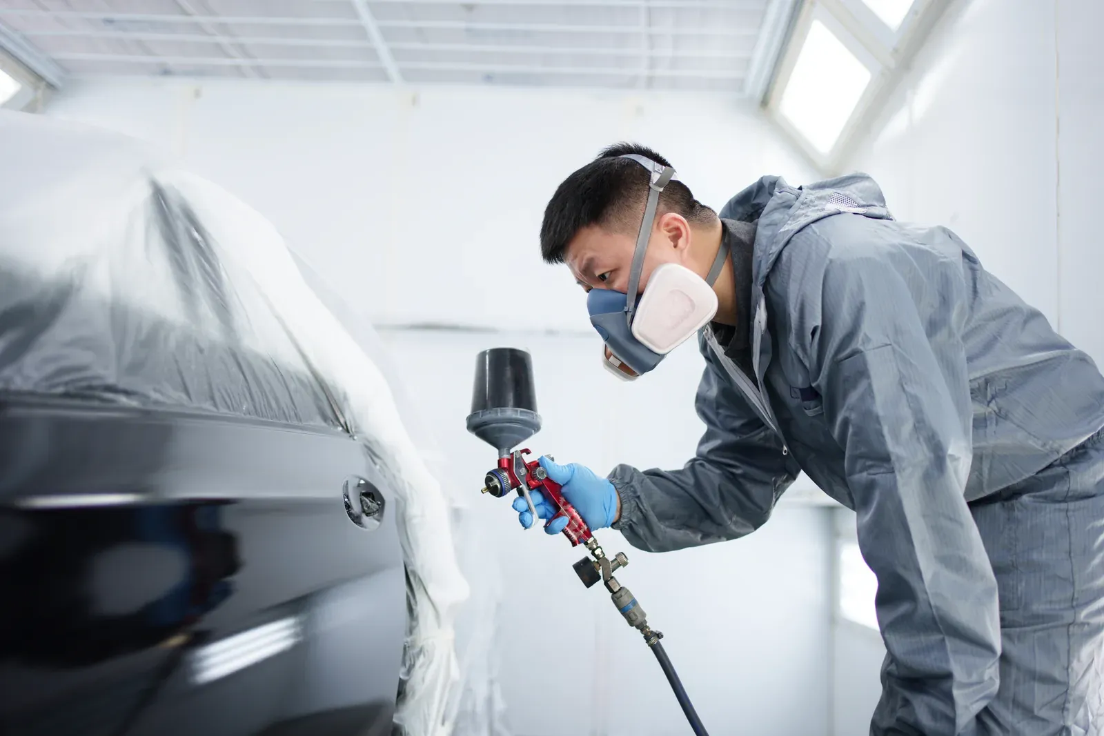 Sedan from Markham being refinished in the spray booth at Collision Auto Center